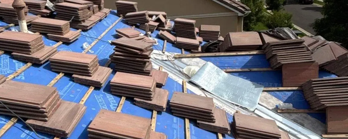 Before, Broomfield, CO: tile roof under a blue tarp