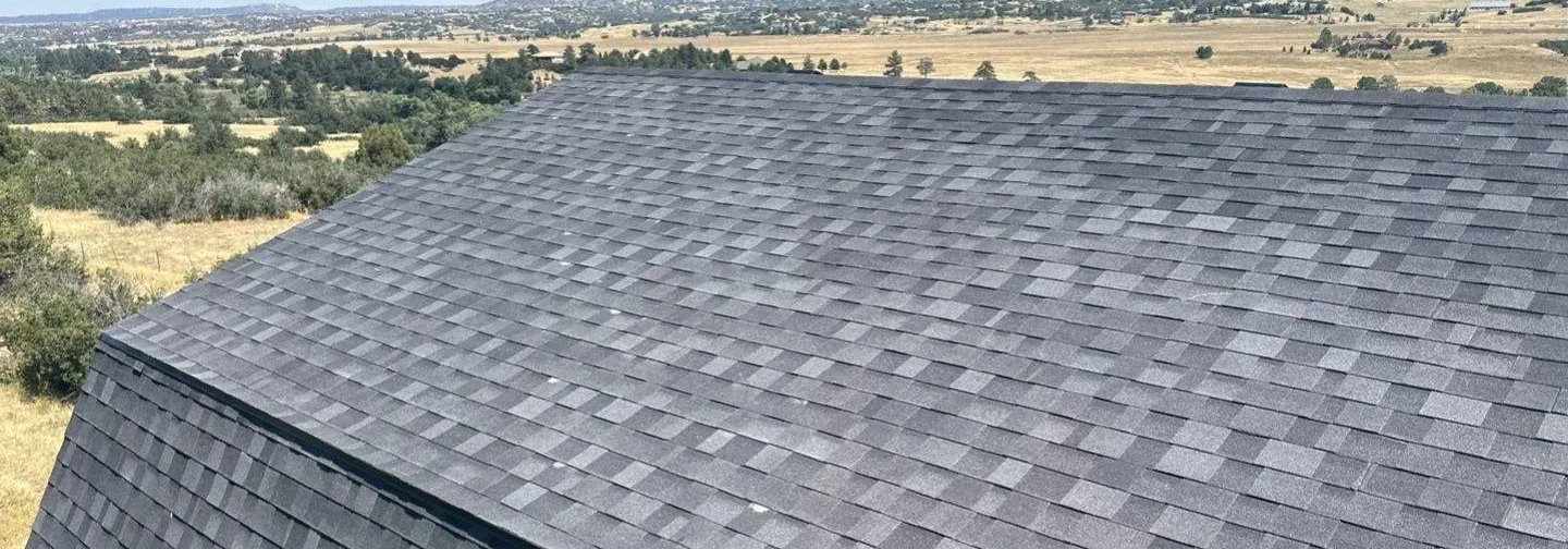 After, Sedalia: new grey architectural shingles with the prairie beyond