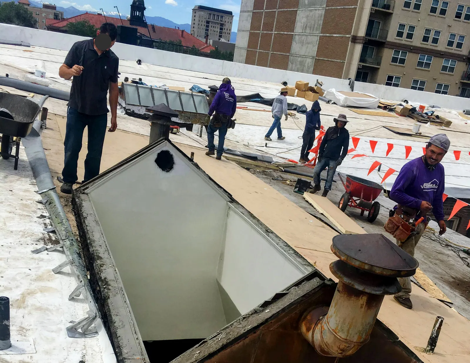 Gen 3 crew mid tear-off on a commercial roof
